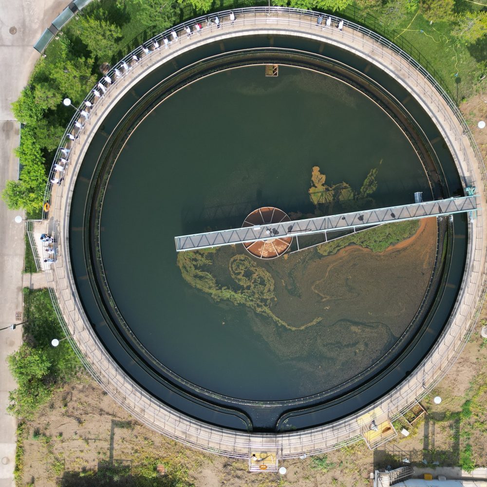 Aerial view of a circular high-rate clarifier and sedimentation tank with its rotating bridge scraper